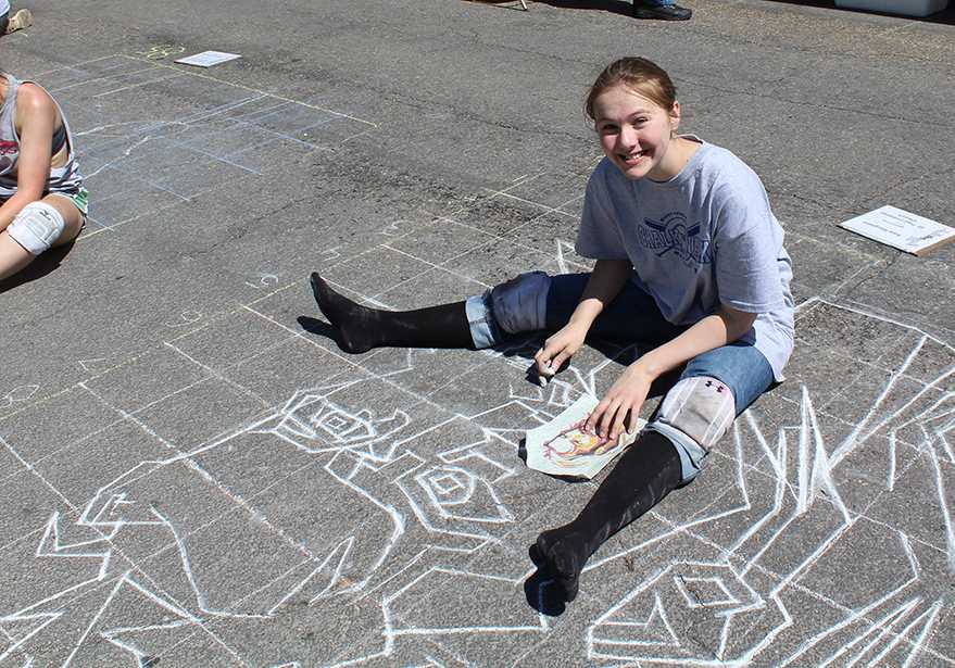 Sophomore Kate Margheim works on her chalk drawing May 6. Photo by Charles Harris.