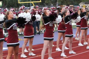 Abigail Patten, junior, cheers on the Mustangs during the game against Solon on Aug. 25.