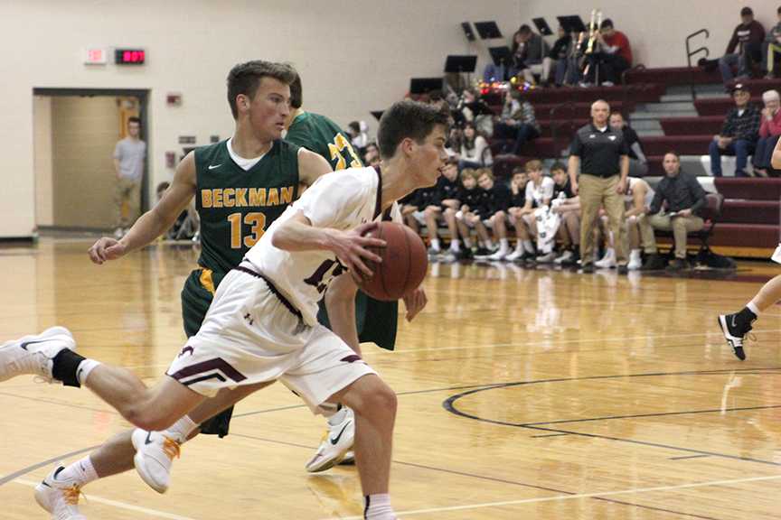 Senior Nick Leopold drives the ball to the basket Dec. 12 against Dyersville Beckman. Leopold scored the game-winning basket, and the Mustangs won. Photo by Emma Klinkhammer.