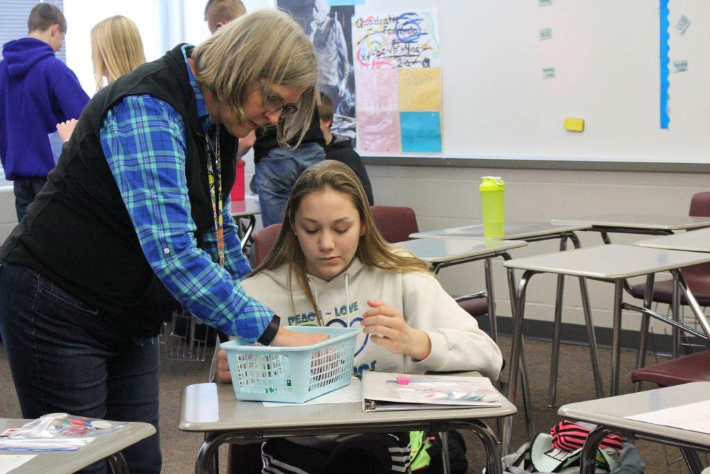 Mrs. Young works with a student in Are You Game?