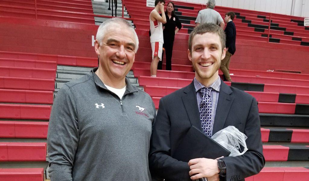 Ed Timm and his son Jake Timm, both boys basketball coaches, pose together after their respective winning games Feb. 19. Mount Vernon beat Dubuque Wahlert 60-57, and Davenport Assumption beat Central DeWitt 64-39.  Photo by Stephanie Timm.