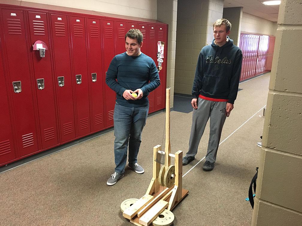 Colin Hallier and Matt Hall revel in the moment of a successful trebuchet launch Feb. 13. Photo by Brian Harris