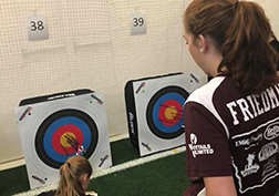 Senior Emily Friedman looks over at her shot at archery meet. 