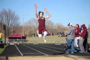 Tyler Elliott jumps during long jump. Elliott placed third at the Solon meet, with a mark of 20 4. Photo by Paige Zaruba. 