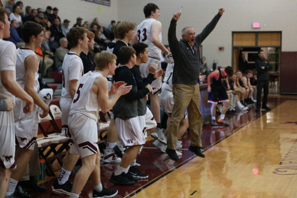Coach Ed Timm and the team celebrate after senior Gabe Randall scores in the fourth quarter. 