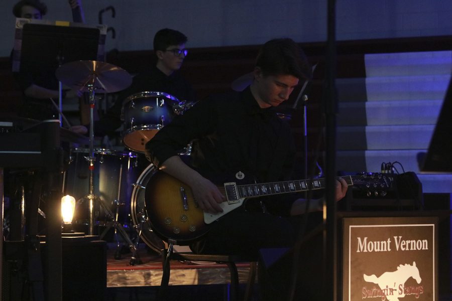 Junior Jack Ossenkop plays the guitar along side the Swinging Stangs at Java Jazz on March 12.