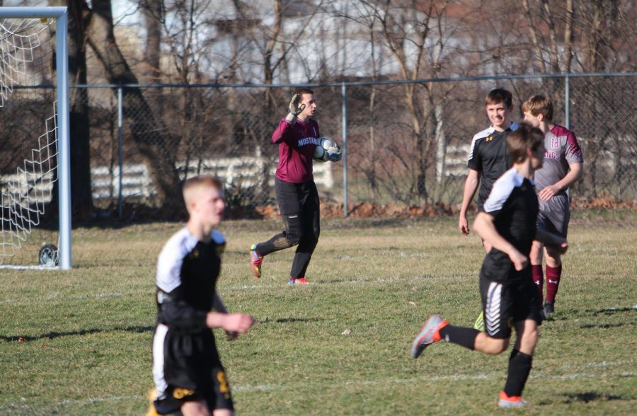 Zach Kolker, senior goalkeeper, calls out his plan as Joe Hunter runs towards the center of the field. 