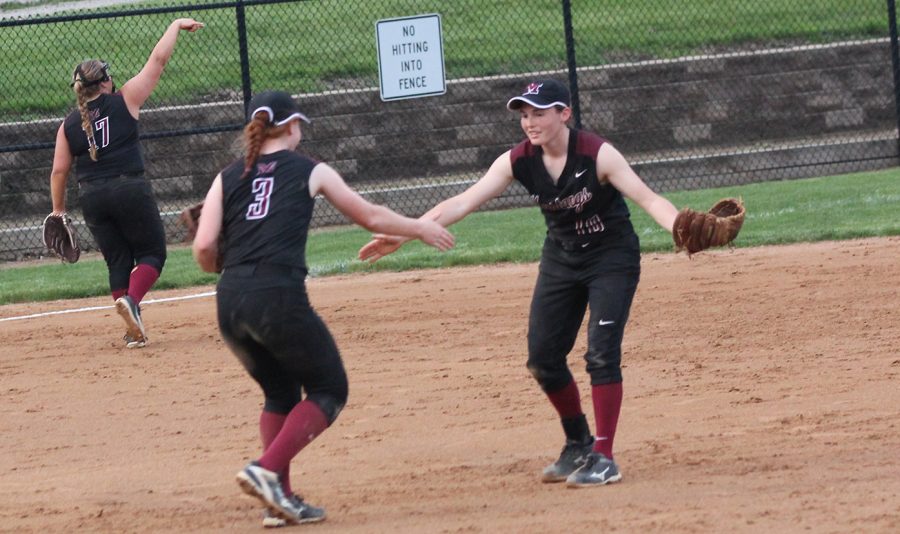 Sammy Moss, an incoming freshman at UNI, and Maia Bentley, incoming sophomore, clap hands during a softball game on May 24. 
