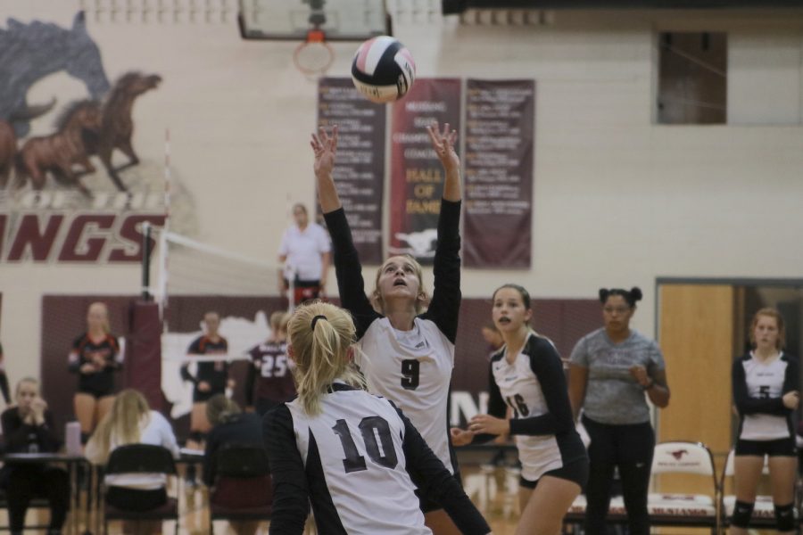Freshman setter Kameron Brand sets the ball to her teammate during the freshman game against West Delaware on Sept. 5.