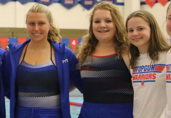 Swimmers Sydney Jones, Michaela Rowell, and Isabel Hawker during a swim meet.