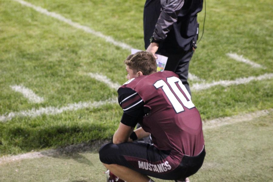 Taking a rest. junior Brady Ketchum watches the defense play during the Sept. 26 homecoming football game. The score was 31-14 with Mount Vernon pulling off the win.
