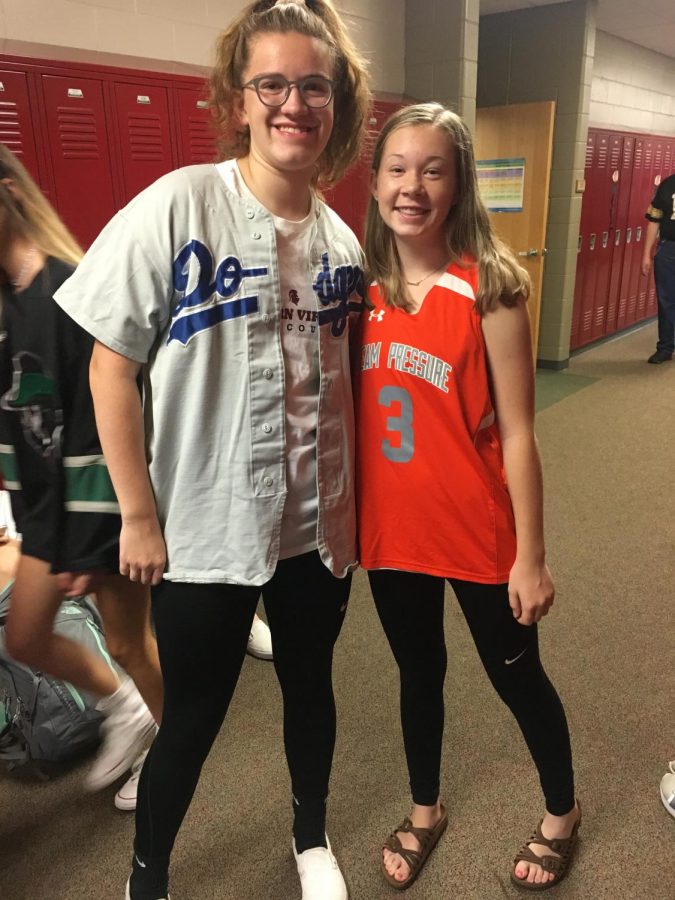 Sophomores McKenzie Rentschler and Macy Eskelsen pose for a picture on Jersey Day for Homecoming Week on Sept. 25. Many students decided to wear jerseys instead of dressing up for fake injury day. 