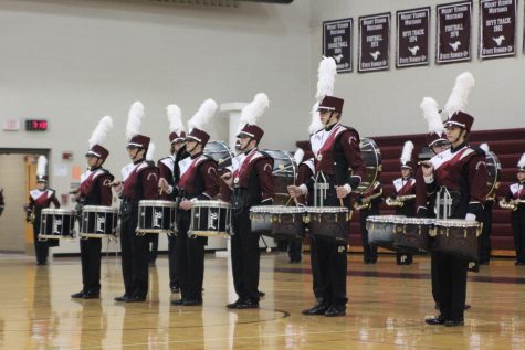 The Marching Mustangs award winning drum line stands at attention during their indoor finale Oct . 24