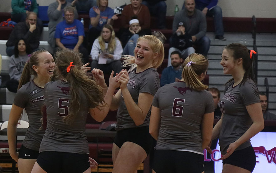 Lauren Schrock celebrates a win with her teammates Oct. 29. The Mustangs beat Jesup in five sets.