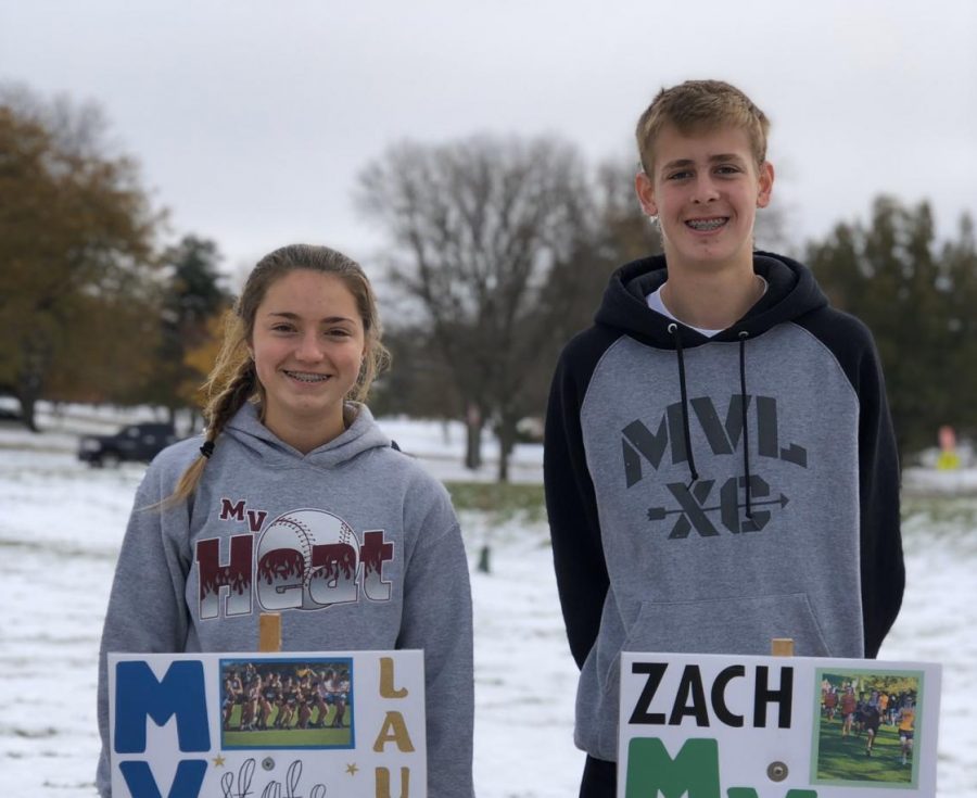 Laura Swart and Zach Fall pose with their state cross country signs.