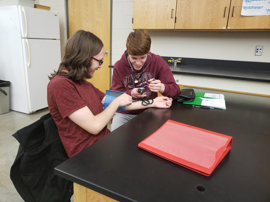 Vaun Remerouski and Tyler Stine take each others blood pressure in Exercise Science Jan. 10.