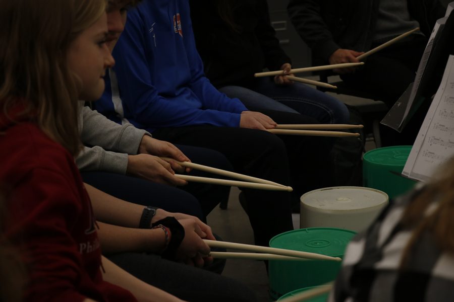 Students in the Festivals, Parades, and Giant Puppets J-term play bucket drums under the direction of Scott Weber Jan. 8.