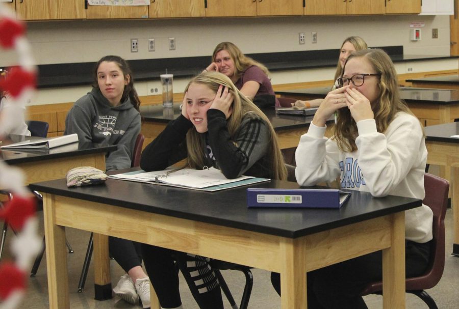 Ooh, gross! Junior Jorie Randall and sophomore Cami Streicher react to video of a shoulder being popped into place during exercise science J-term class.