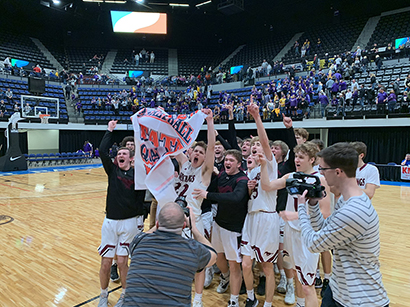 Mount Vernon Boys basketball team celebrates after winning the regional finals game at the U.S. Cellular Center on March 2.