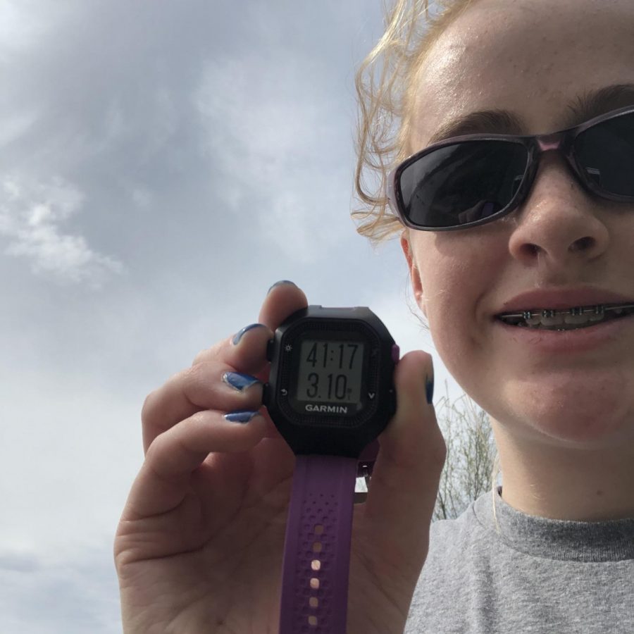 Freshman Madeleine Miller poses with her time in the 5K Challenge on May 1. One hundred and thirty students participated in the event which raised $1335.00 for the Mustang Strength and Speed program.
