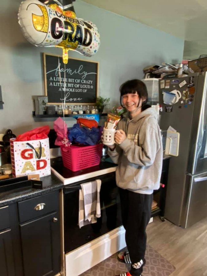 Lexi Flockhart poses with her gifts from the Hanson family May 13.