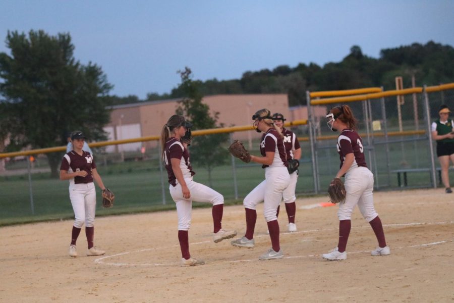 Nicole Sullivan gives Summer Brand a kick to celebrate  striking out a batter in  Dyersville June 15. Mount Vernon beat Beckman Catholic 11-1.