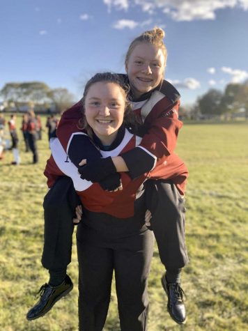 Jaegan Becthold holds her friend Lauren Swartzendruber while at a marching band competition in 2019. 