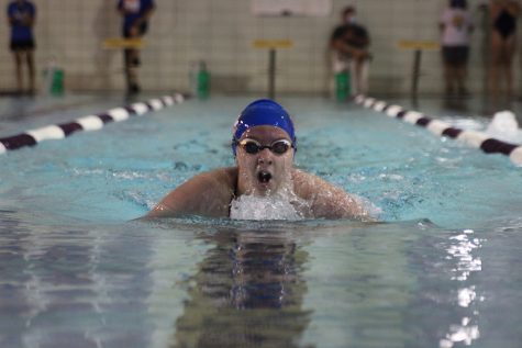 While swimming the 100 breaststroke, freshman Cora Wheeler comes up for a breath Sept. 3. Photo by Lillie Hawker.