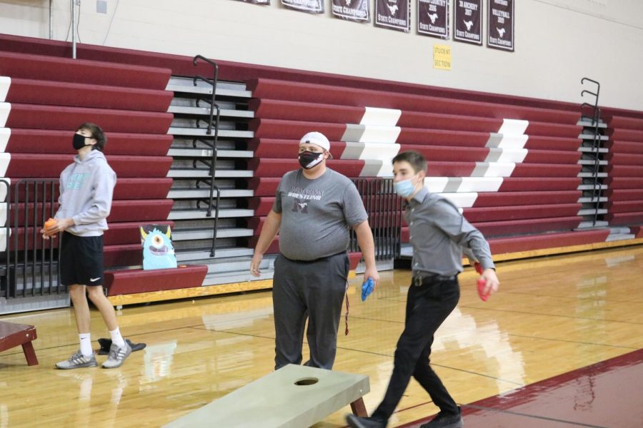 Students play bags at the Halloweentown homecoming party Oct. 10. 