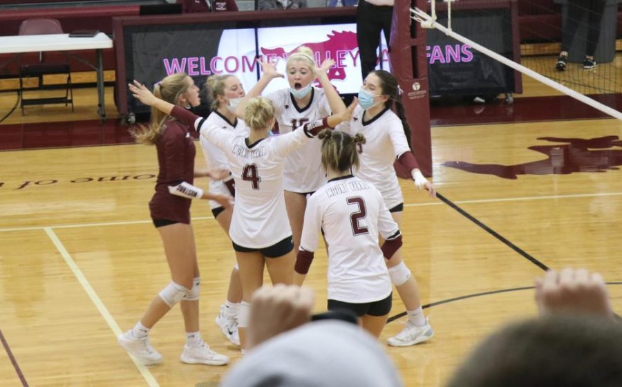 The Mustangs celebrate a point in the third winning set against Williamsburg Oct. 21.