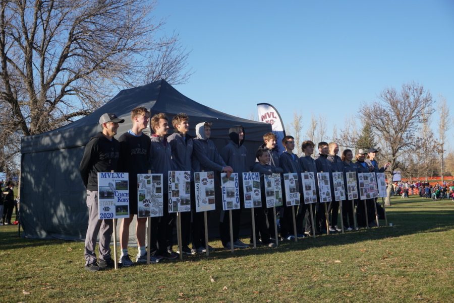 The boys team line up with their state pictures for a photo
