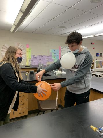 Science teacher Michaela Just helps freshman Joey Rhomberg measure a balloon in Chemistry 1 Feb. 3. 