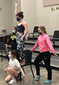 Junior Abbey Keen, sophomores Claire Gaffney and Ava Dimmer, and junior Ashlee Elliot practice blocking during a musical theatre rehearsal.