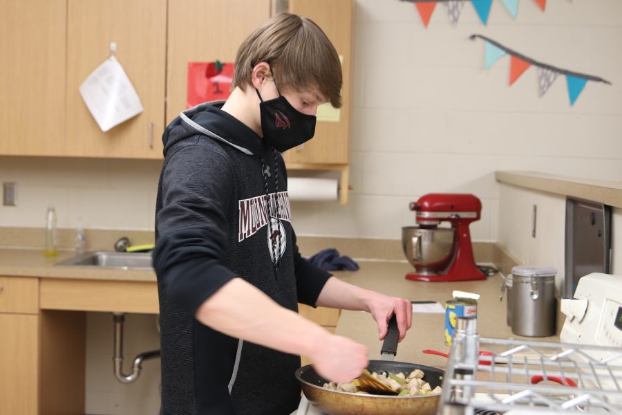 Leo Appleton, a junior, cooks his food in a skillet in Foods 1 Feb. 3.