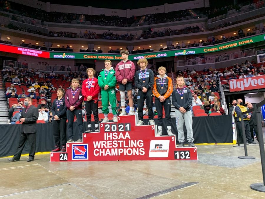 Jackson Jaspers stands on the podium for state class 2A wrestling.
