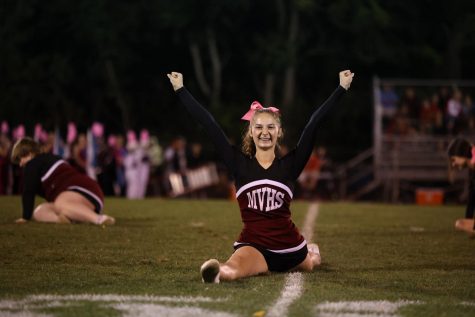 Sophomore Emily Patten ends the halftime cheer performance in the splits Oct. 1. 