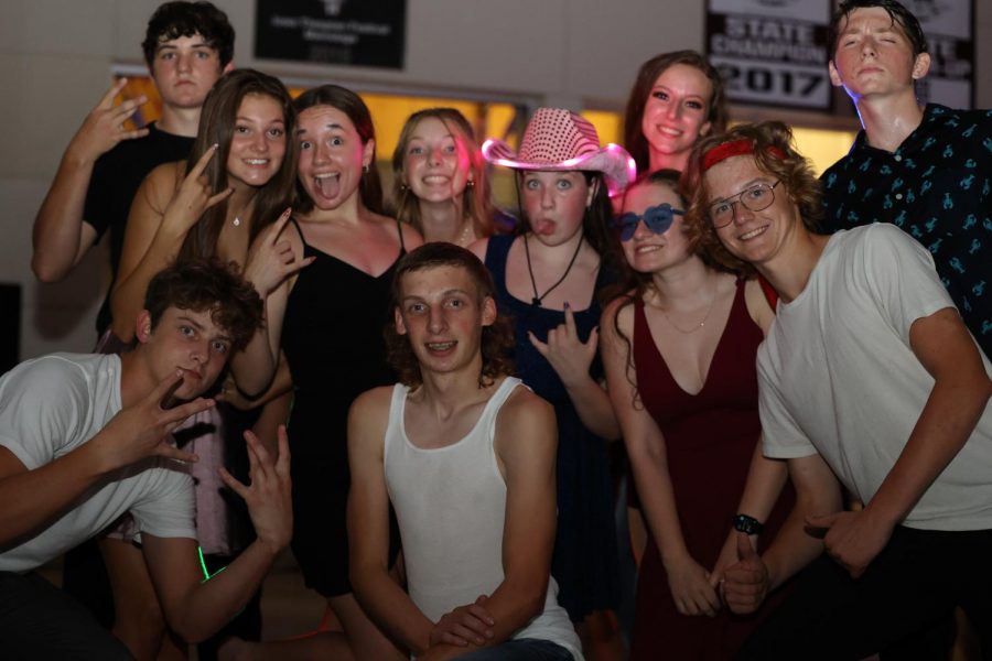 A group of students pose for a picture on the dance floor.