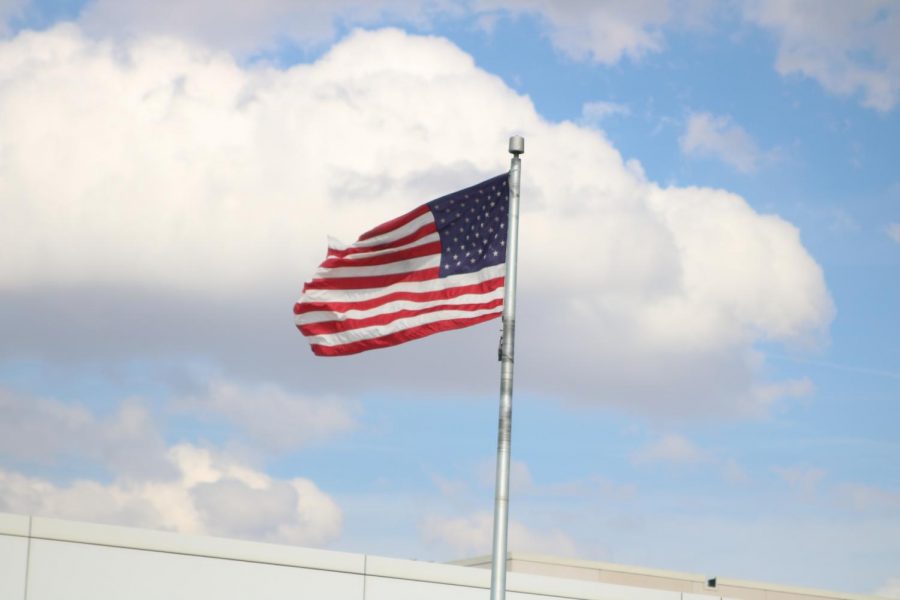 The flag flied outside the high school building and hangs in each classroom. Schools in Iowa are required this year to lead students in the Pledge of Allegiance, but students are not required to say it.