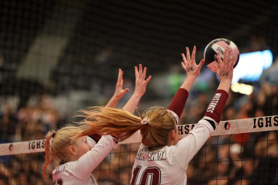 Juniors Parker Whithem and Madeline Miller go up for a block against West Libertys hit. 