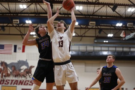 Sophomore Evan Brase goes up for a basket against Benton Feb. 11. The Mustangs won 60-46 with Brase scoring 13 points.
