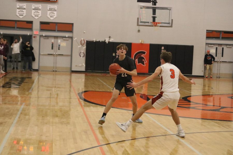 Sophomore Jackson Kutcher looks to pass the ball to his teammate 
