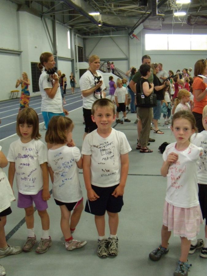 Mae Owen, Aden Grudzinski, and Quinlan Denes pose for the camera at the kindergarten olympics.