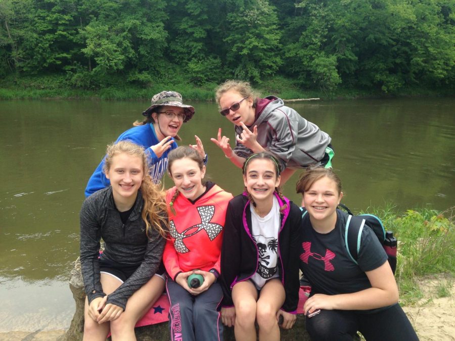 Macy Eskelsen, Celine Manternach, Madelyn Plotz, Quinlan Denes, Kambree Hultquist, and Abbey Keen pose for a picture after canoeing in seventh grade.