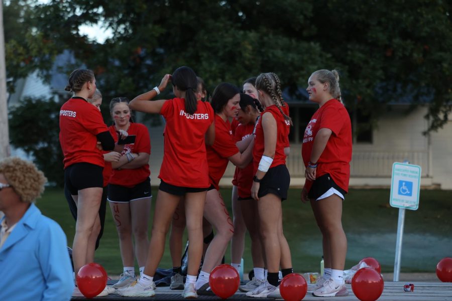Senior-Sophomore powderpuff team, the Imposters, deliberate on their float ahead of the parade.
