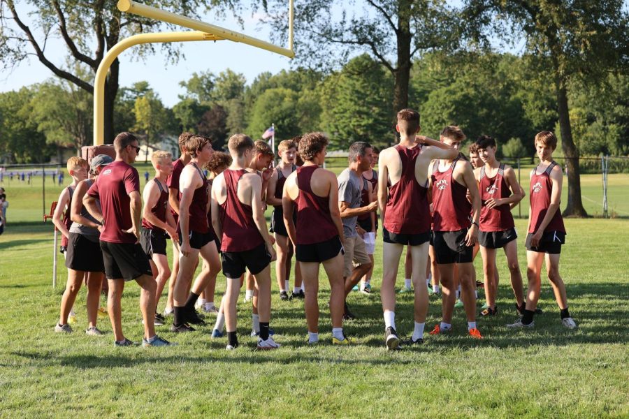 Cross country coach Kory Swart gives the boys team a pep talk before their first meet of the season.