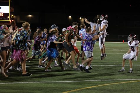Quarterback, Joey Rhomberg meets with the student section as they celebrate in disbelief after beating the Solon Spartans 17-14 on Sept. 2.