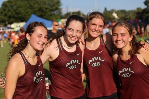 Junior Emily Patten, sophomore Clare Nydegger, junior Anna Vavricek, and junior Audrey Tucker smile for a picture after their race.