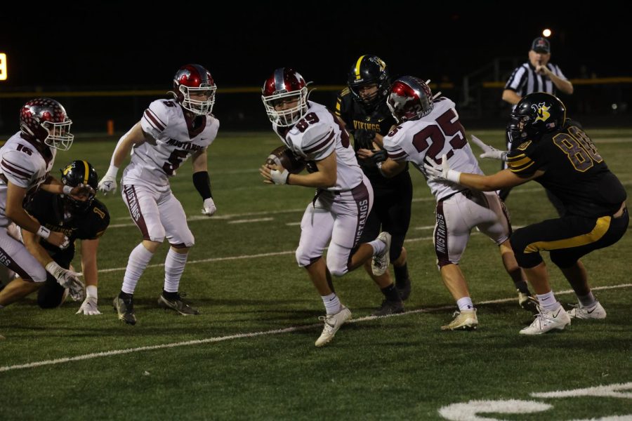 Freshman Jace Jaspers (89) dodging the Vikings to make a run down the sideline.