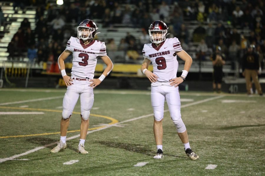 Senior Henry Ryan (3) and Joey Rhomberg (9) stand in the same stance waiting for a play to be announced.