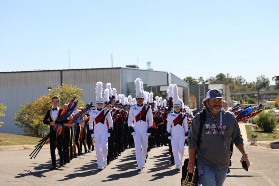 Band director Scott Weber leads the Marching Mustangs to the field at the state competition held at Kingston Stadium on Oct. 8.